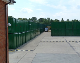 cheap mini warehousing Ranks of green storage containers at the Eversley site